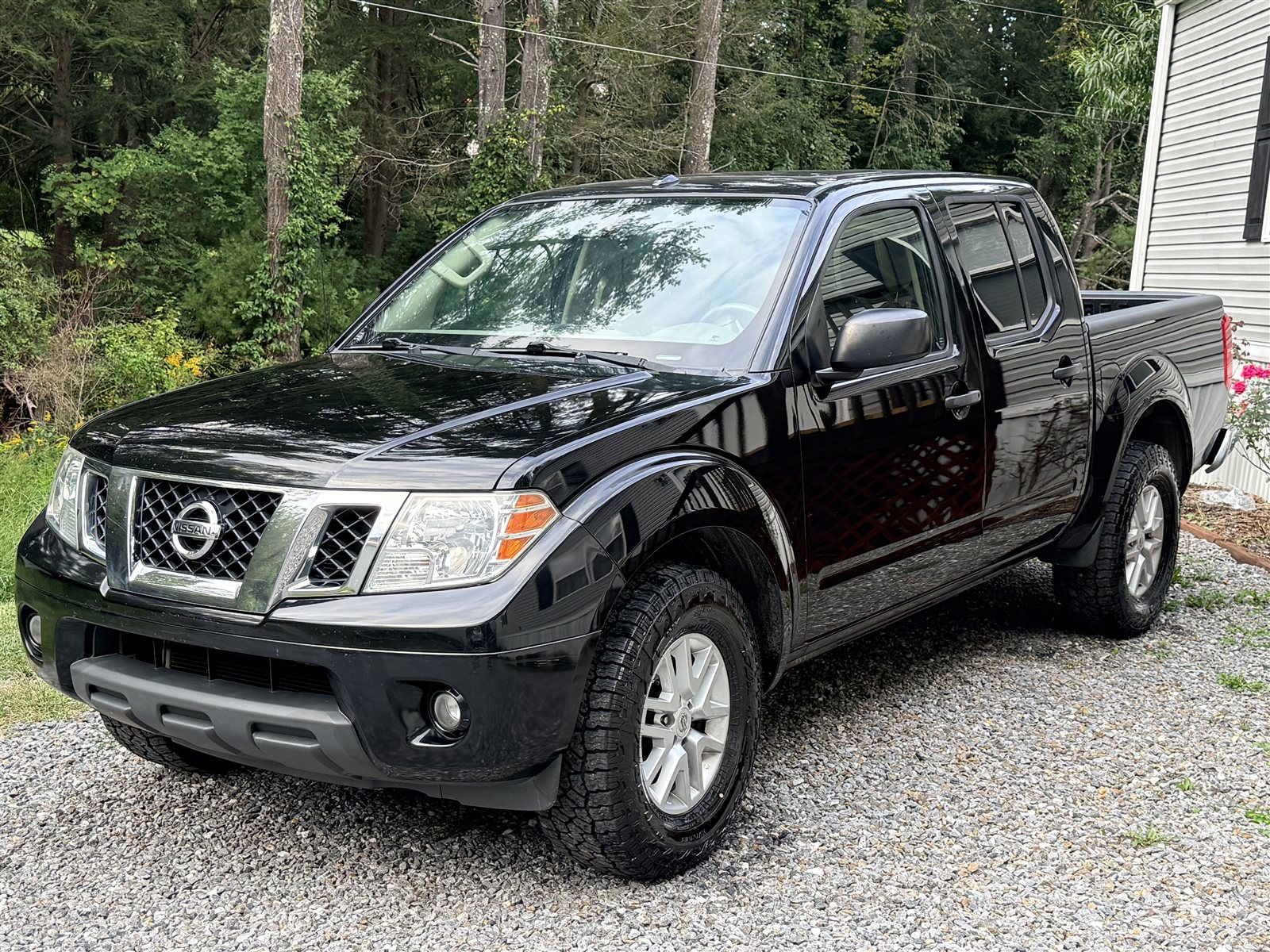 Detailed black Nissan pickup with reflective paint