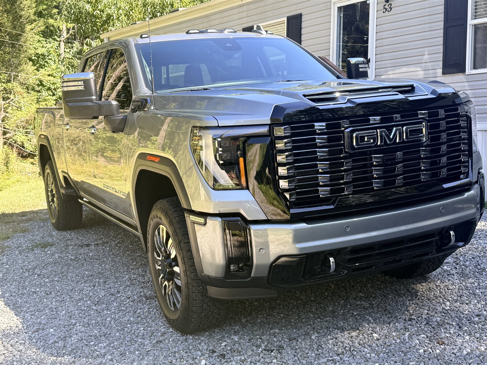 Detailed silver GMC pickup parked in a driveway
